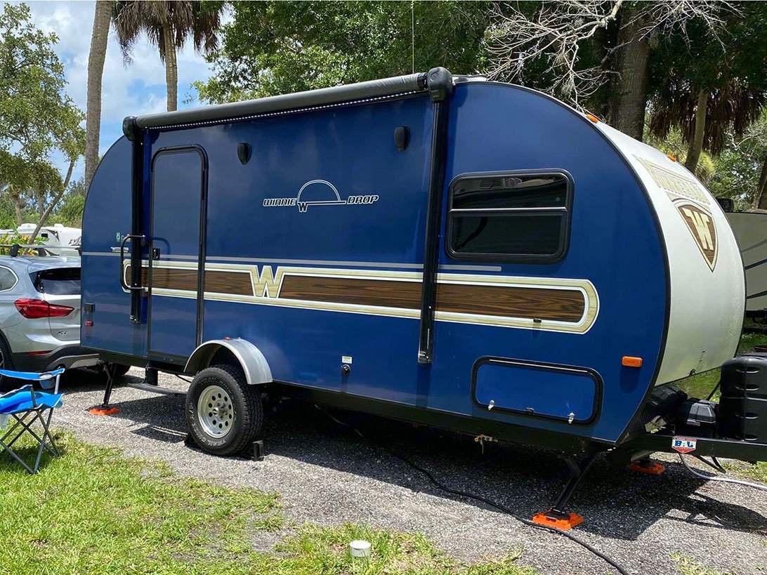 Exterior view of a Blue RV camper parked outside.