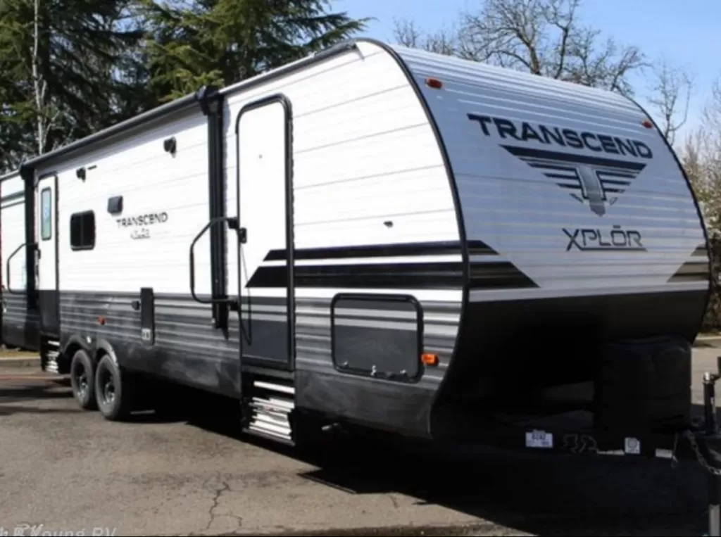 Outside view of an RV camper with the name "Transcend"